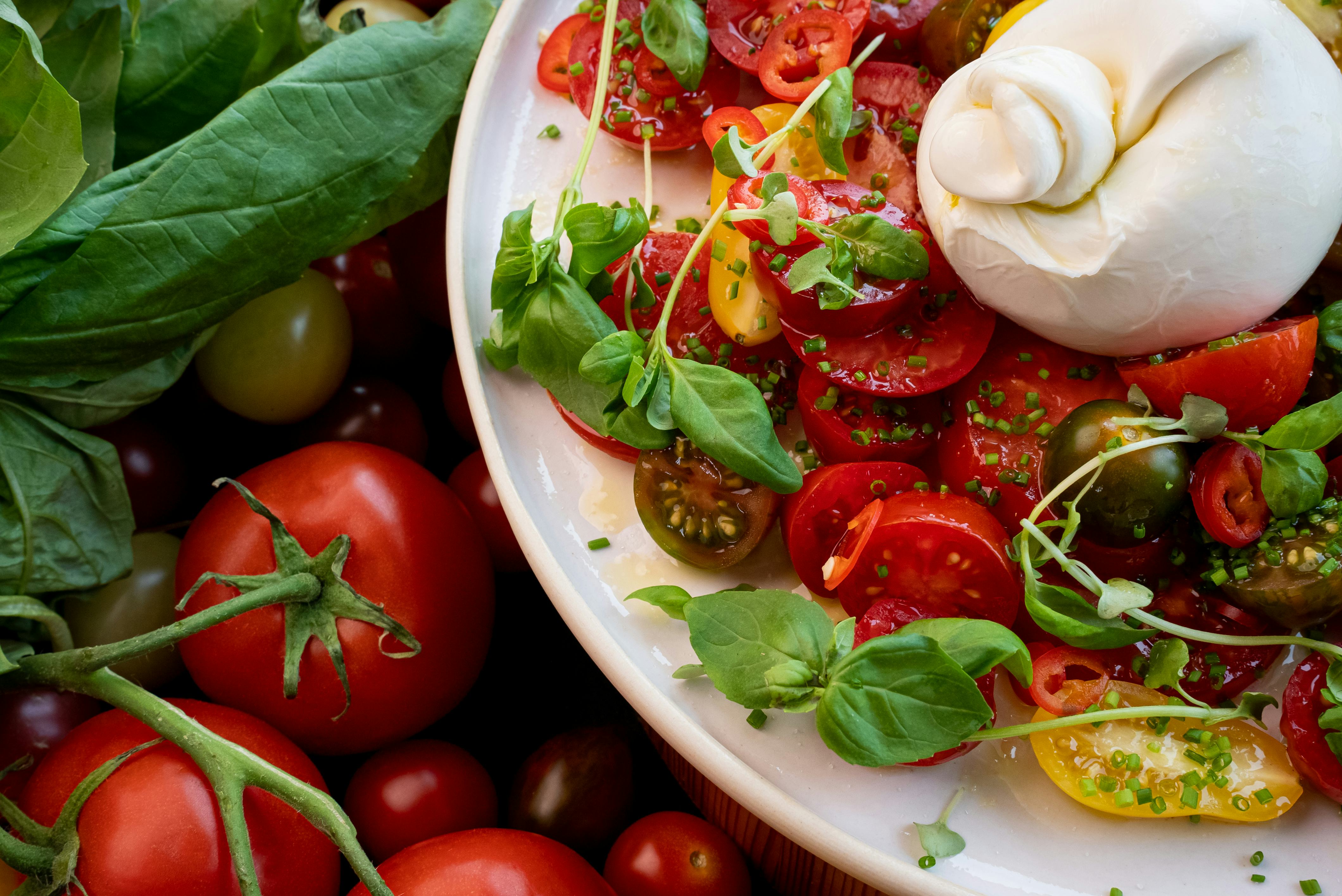 A beautiful caprese salad with basil and heirloom tomatoes.
