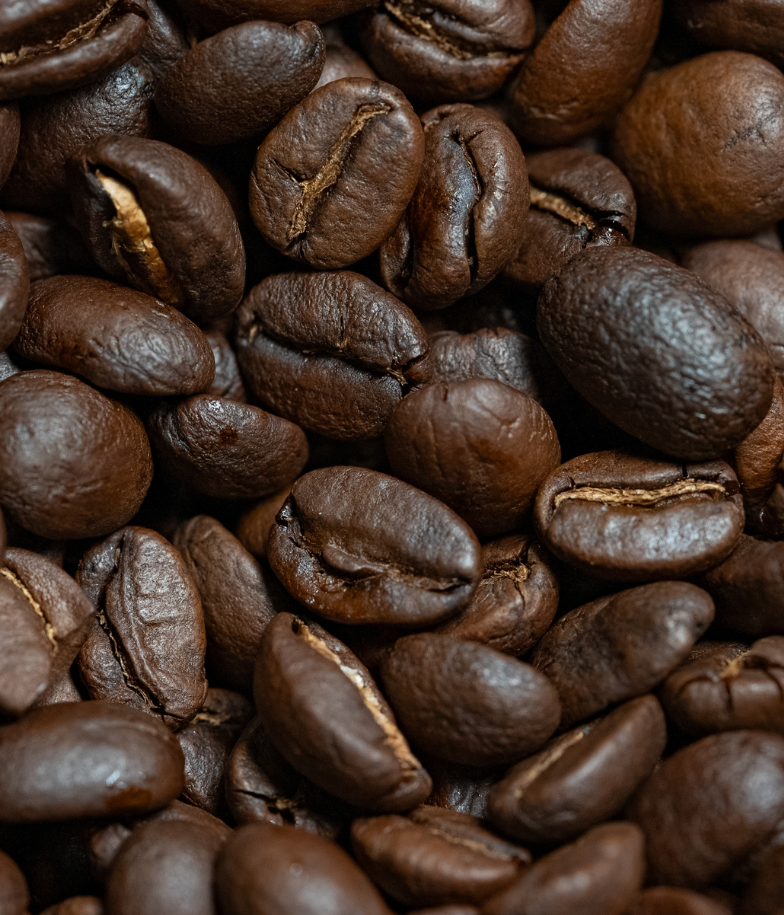 A close-up macro photo of coffee beans.